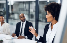 Shot of a young businesswoman delivering a presentation to her colleagues in the boardroom of a modern office