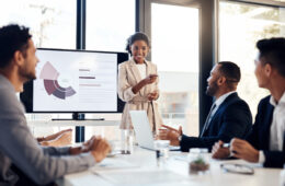 Shot of a young businesswoman delivering a presentation to her colleagues in the boardroom of a modern office