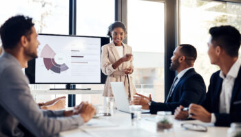 Shot of a young businesswoman delivering a presentation to her colleagues in the boardroom of a modern office