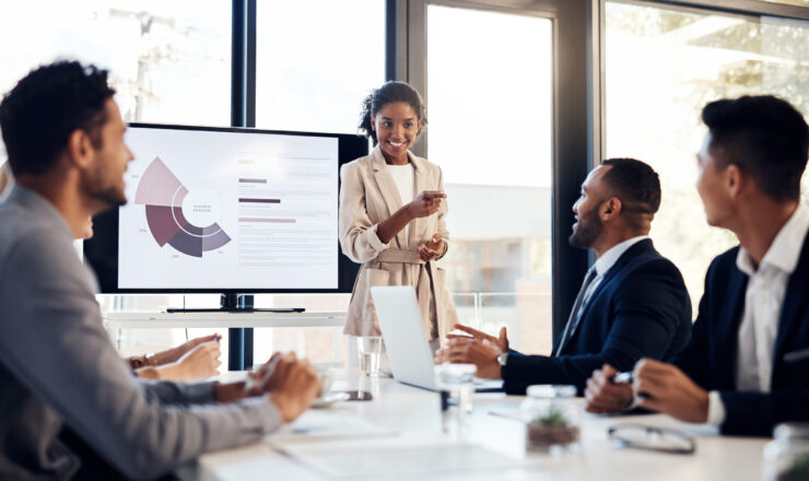 Shot of a young businesswoman delivering a presentation to her colleagues in the boardroom of a modern office